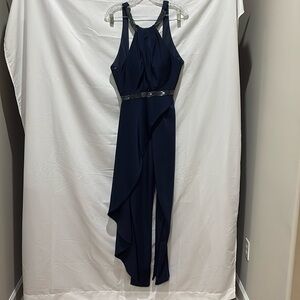 Rachel Allan  couture navy jumpsuit with side decor on right.
